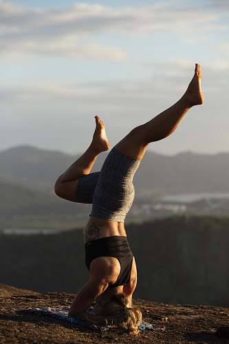 sport woman doing yoga on hill sports